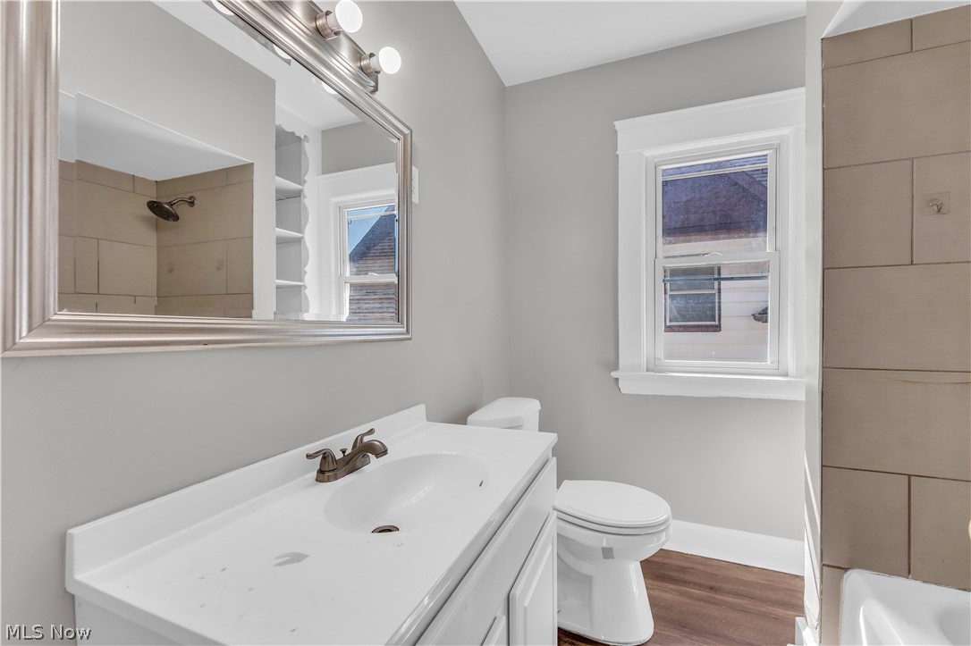 3506 Riverside Avenue Cleveland, OH 44109 - Photo 22 of 31 Bathroom featuring a white vanity with integrated sink, bronze-finish faucet, and coordinating framed mirror
