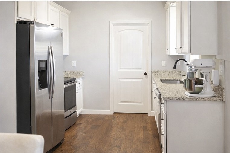 809 Hooper Road Charlotte, TN 37036 - Photo 5 of 14 a kitchen with a refrigerator sink and cabinets