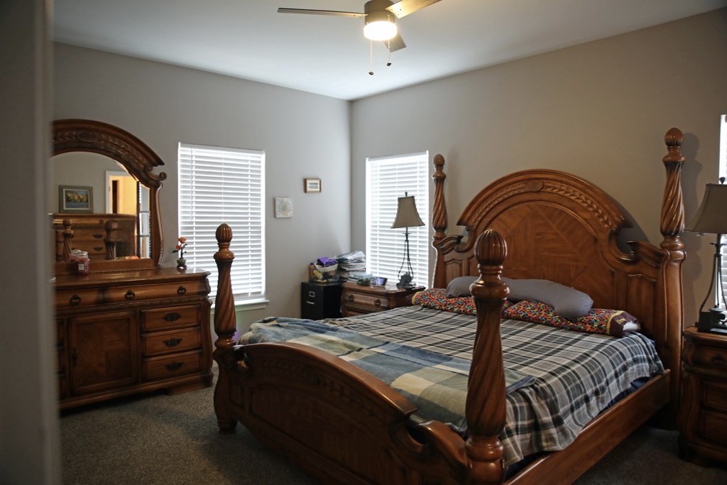 809 Hooper Road Charlotte, TN 37036 - Photo 8 of 14 a bedroom with a bed and dresser