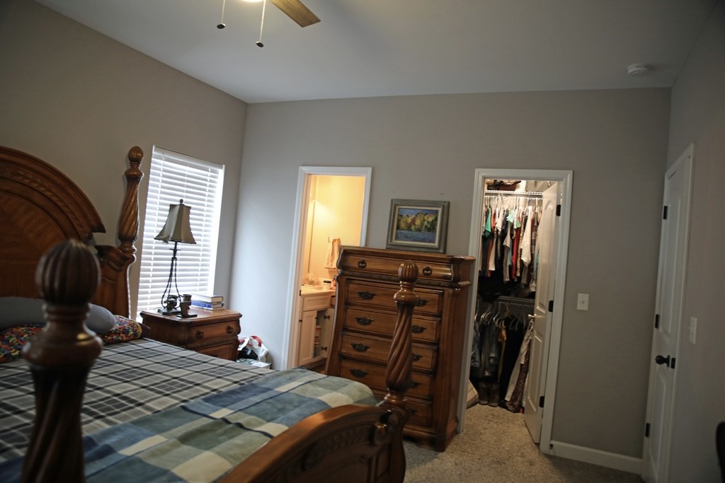 809 Hooper Road Charlotte, TN 37036 - Photo 9 of 14 a bedroom with a bed and wooden floor