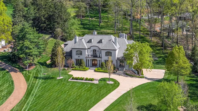 an aerial view of a house with a yard table and chairs