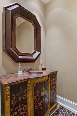 a spacious bedroom with a bed and a chandelier