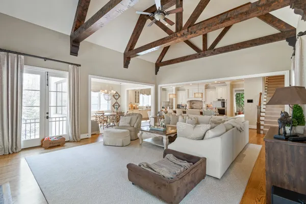 a living room with furniture a flat screen tv and a window