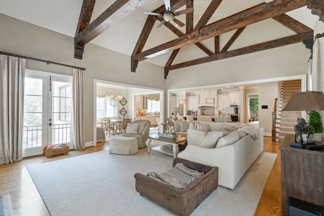 a living room with furniture a flat screen tv and a window