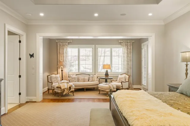 a view of a swimming pool and lounge chairs in back yard
