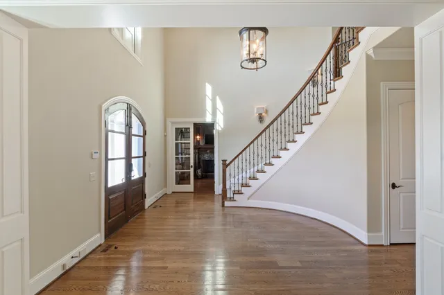 a dining room with furniture a chandelier and wooden floor