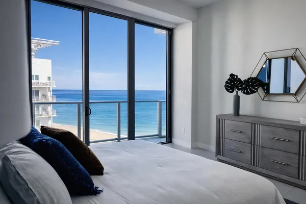 a bedroom with a large bed and a window