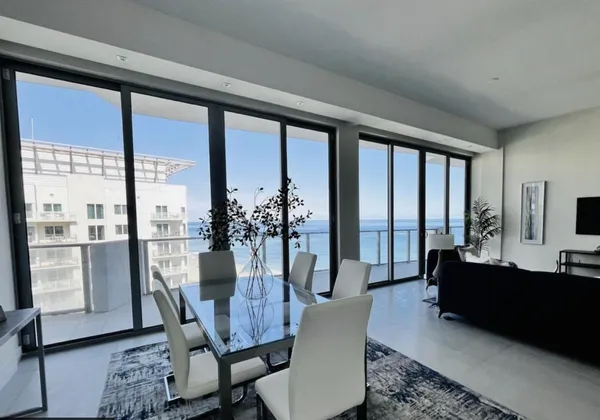 a view of a dining room with furniture window and wooden floor