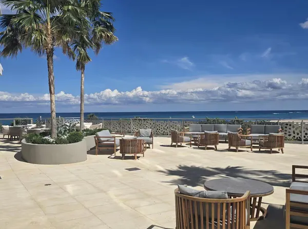 a view of swimming pool with outdoor seating and a potted plant