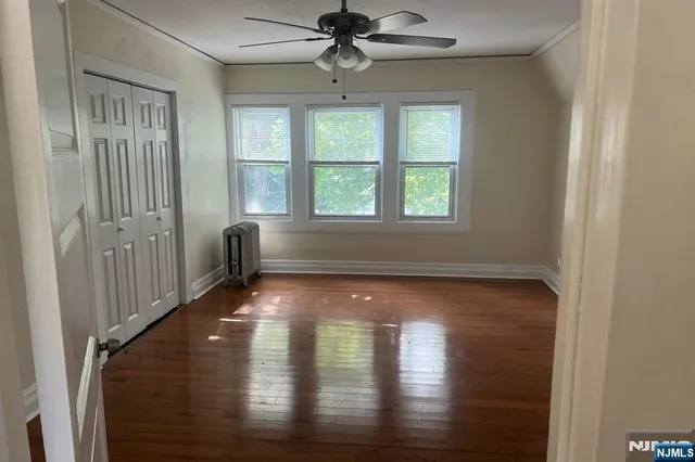 a view of dining room with wooden floor fan and a window