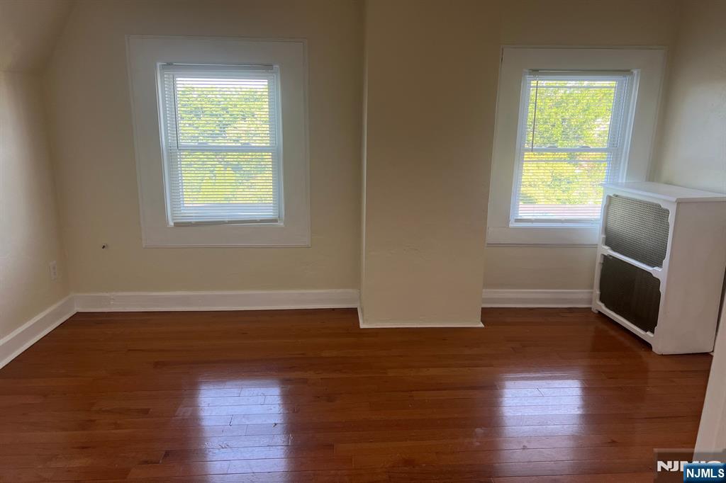 19 Spring Street, Unit 2 Bloomfield, NJ 07003 - Photo 15 of 19 an empty room with wooden floor and windows