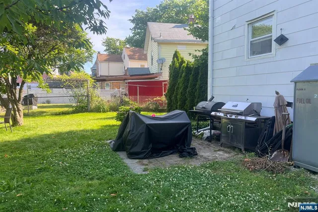 a view of a backyard with sitting area and garden