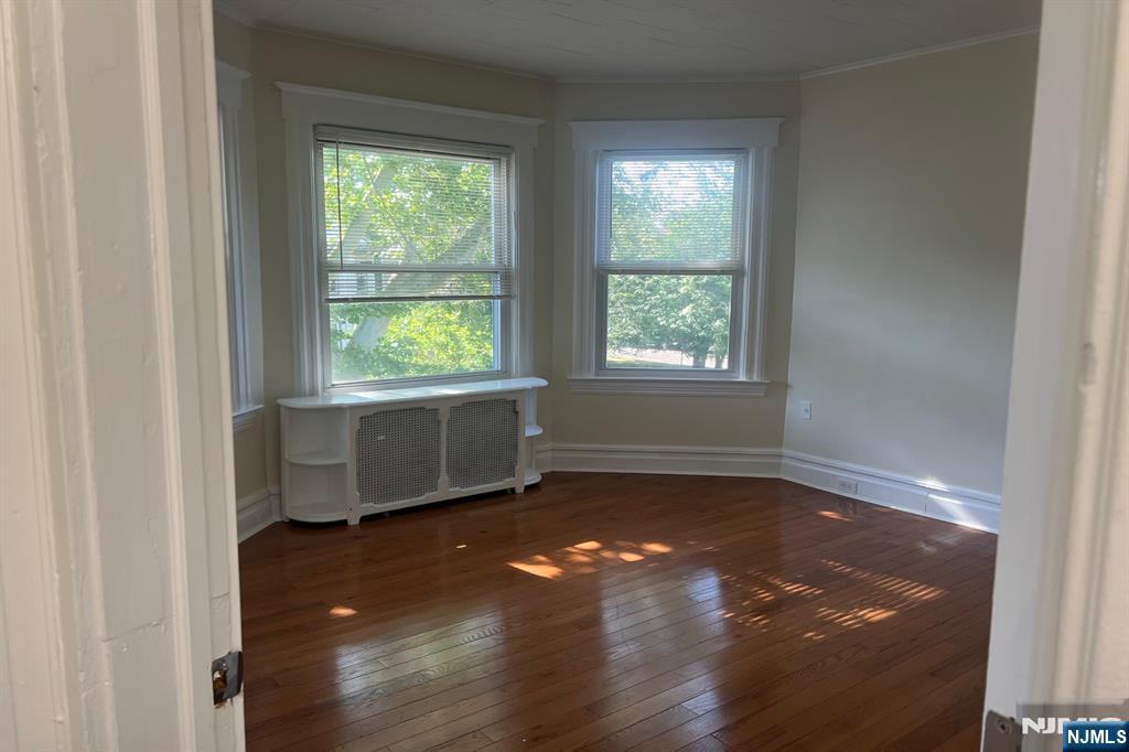19 Spring Street, Unit 2 Bloomfield, NJ 07003 - Photo 3 of 19 an empty room with wooden floor and windows