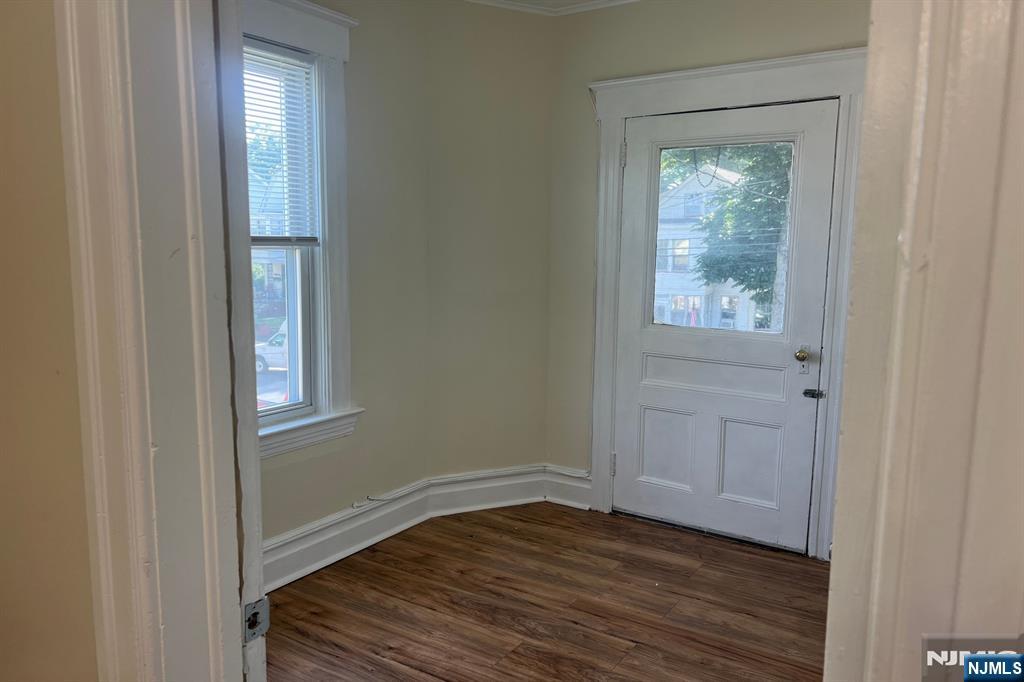 19 Spring Street, Unit 2 Bloomfield, NJ 07003 - Photo 4 of 19 a view of an empty room with wooden floor and a window