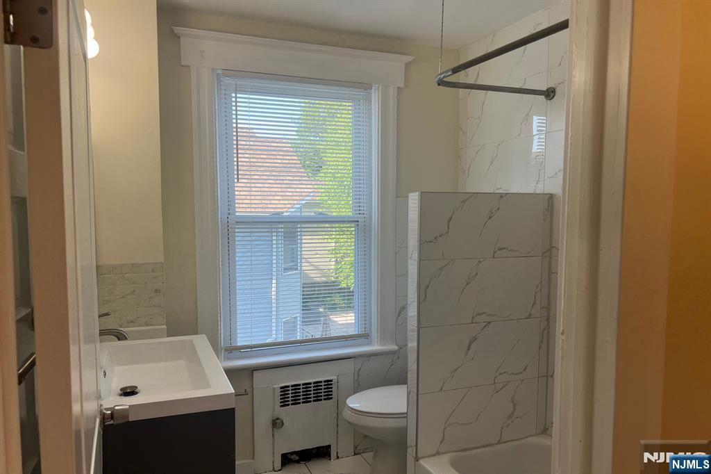 19 Spring Street, Unit 2 Bloomfield, NJ 07003 - Photo 7 of 19 a bathroom with a sink a toilet and shower