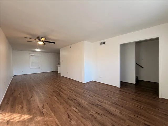 a view of an empty room and wooden floor