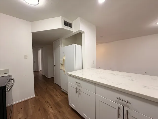 a utility room with cabinets washer and dryer