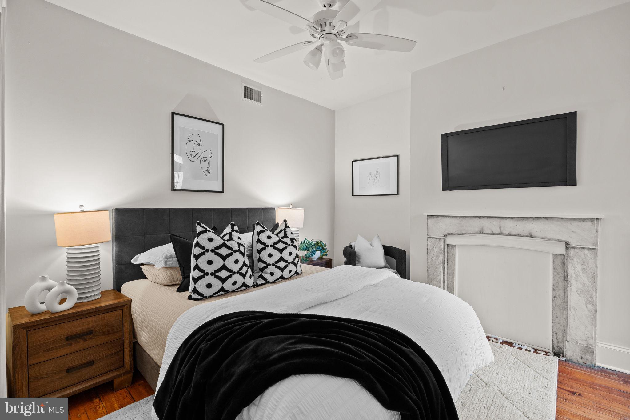 1708 Pine Street, Unit 3F Philadelphia, PA 19103 - Photo 13 of 19 a bedroom with a bed and a flat tv screen