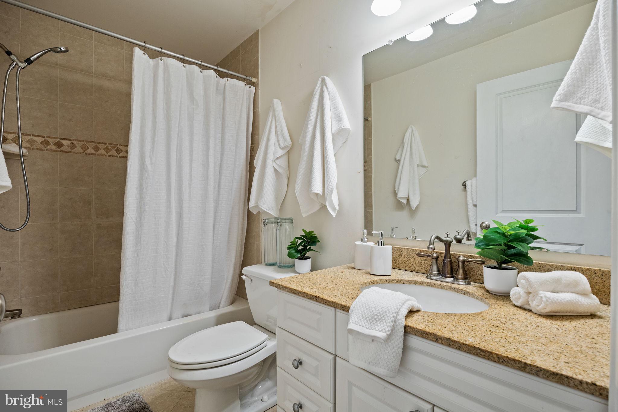 1708 Pine Street, Unit 3F Philadelphia, PA 19103 - Photo 16 of 19 a bathroom with a granite countertop sink toilet and shower