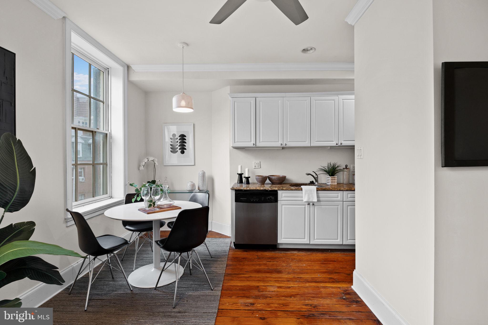 1708 Pine Street, Unit 3F Philadelphia, PA 19103 - Photo 6 of 19 a kitchen with sink refrigerator dining table and chairs