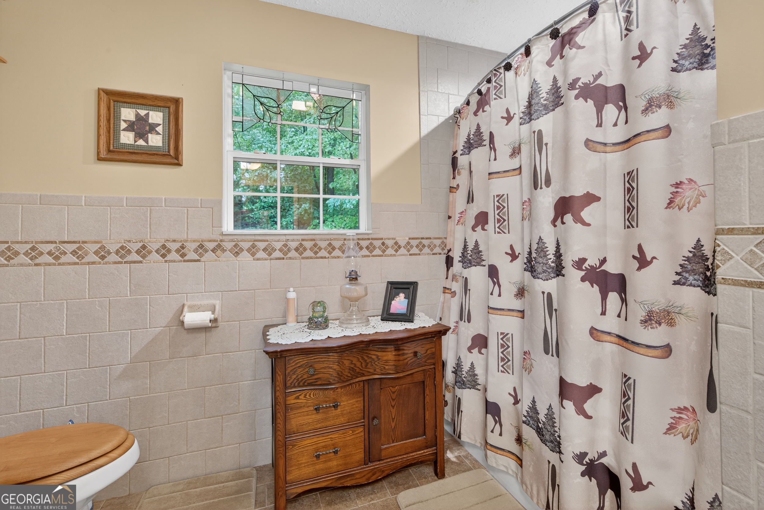 75 Juniper Trail Clayton, GA 30525 - Photo 22 of 38 a bathroom with a granite countertop sink a toilet and a shower curtain