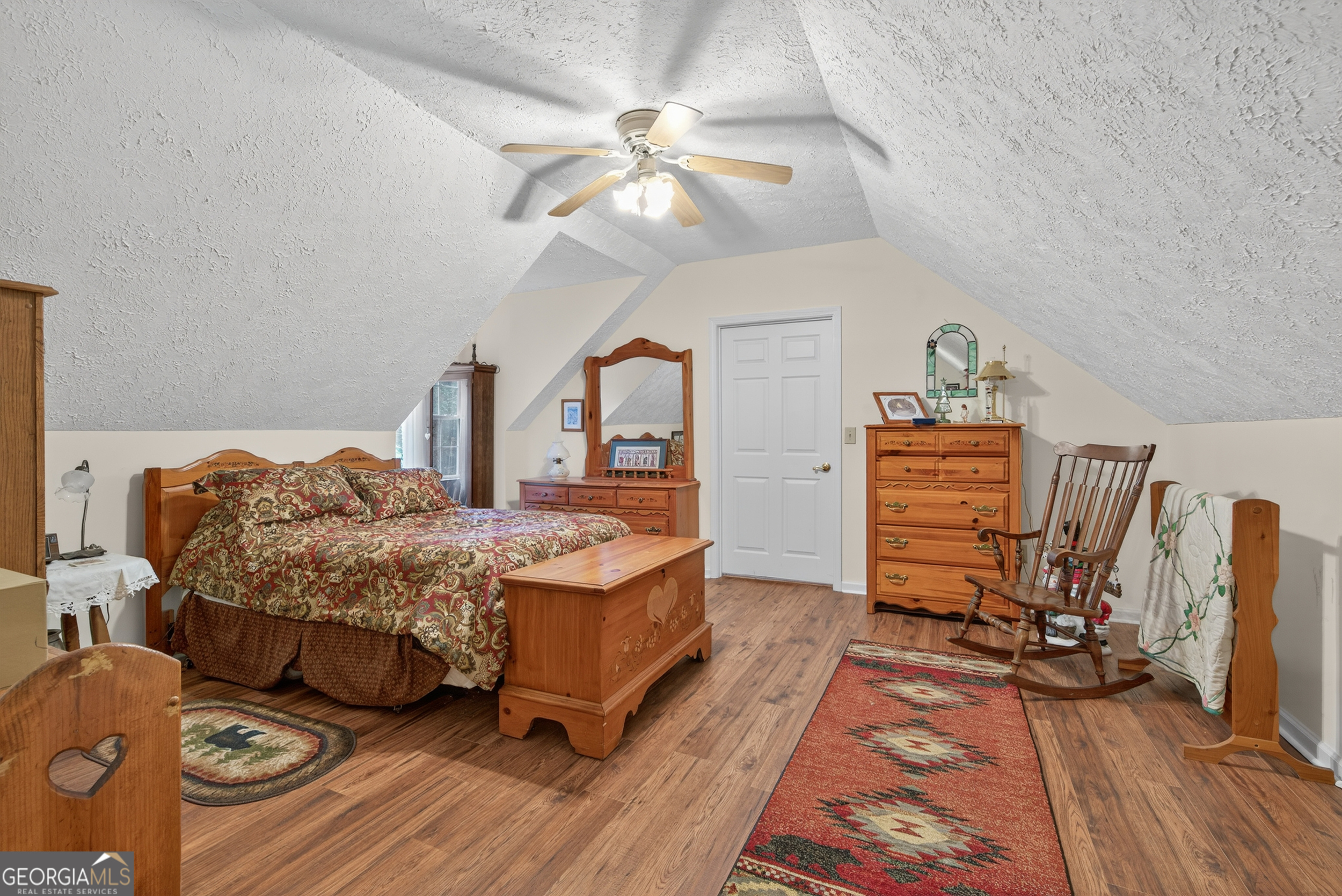75 Juniper Trail Clayton, GA 30525 - Photo 24 of 38 a bedroom with a bed and a chandelier