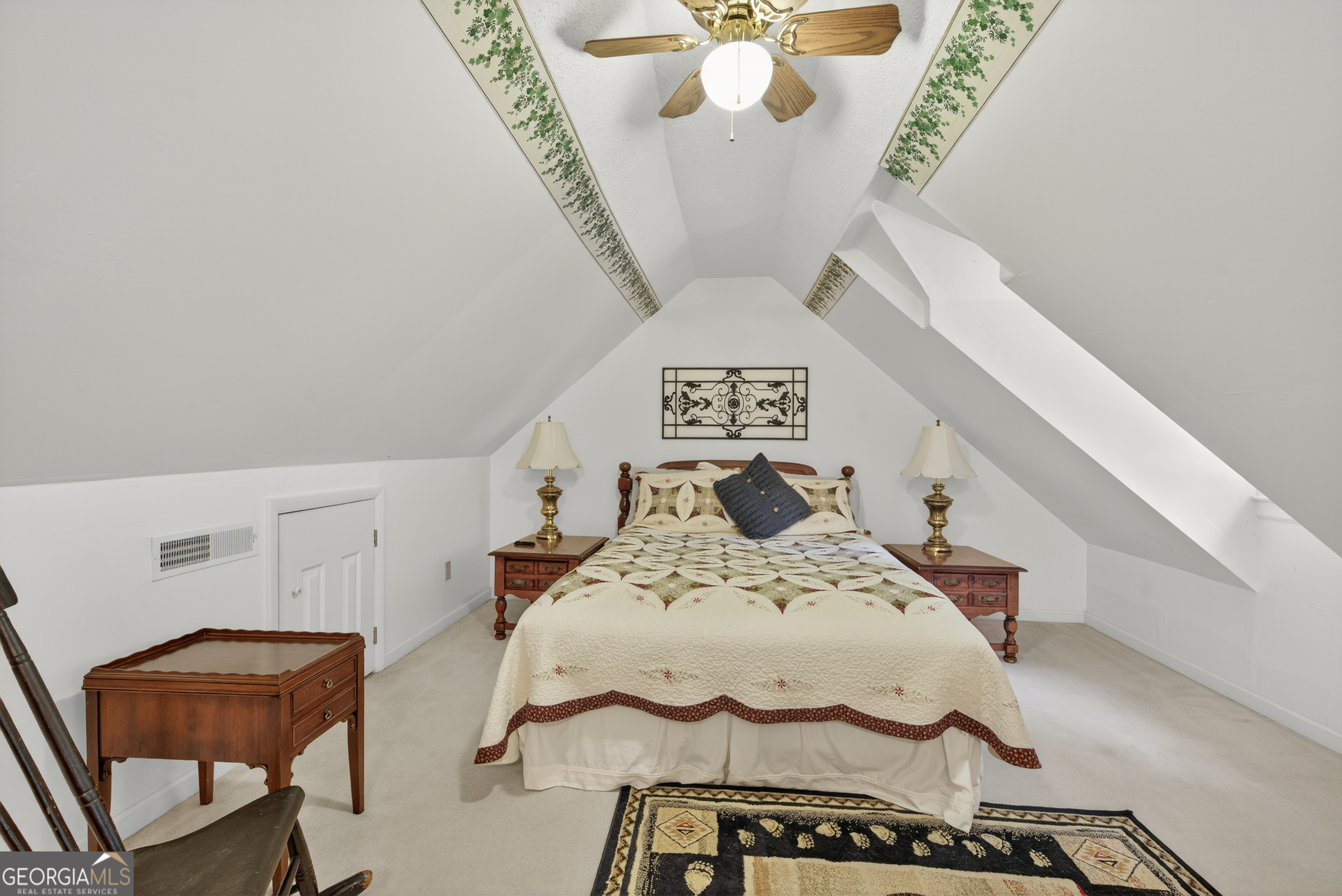 75 Juniper Trail Clayton, GA 30525 - Photo 26 of 38 a bedroom with a bed and a chandelier