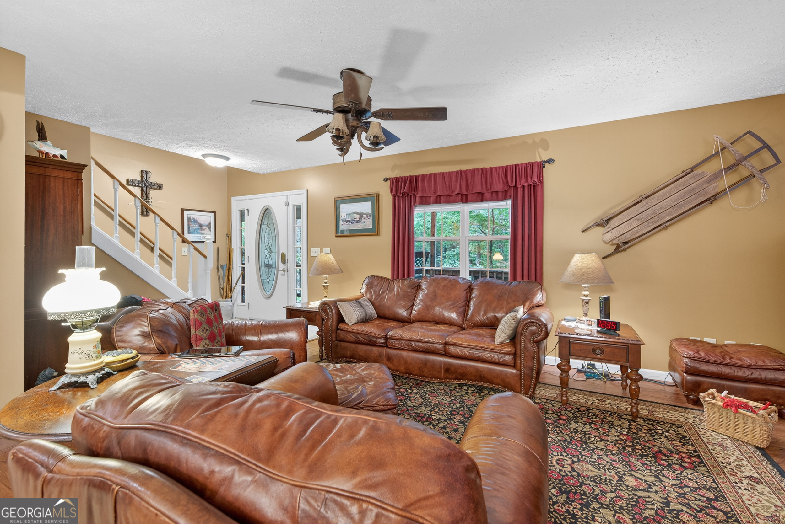 75 Juniper Trail Clayton, GA 30525 - Photo 5 of 38 a living room with furniture ceiling fan and a rug