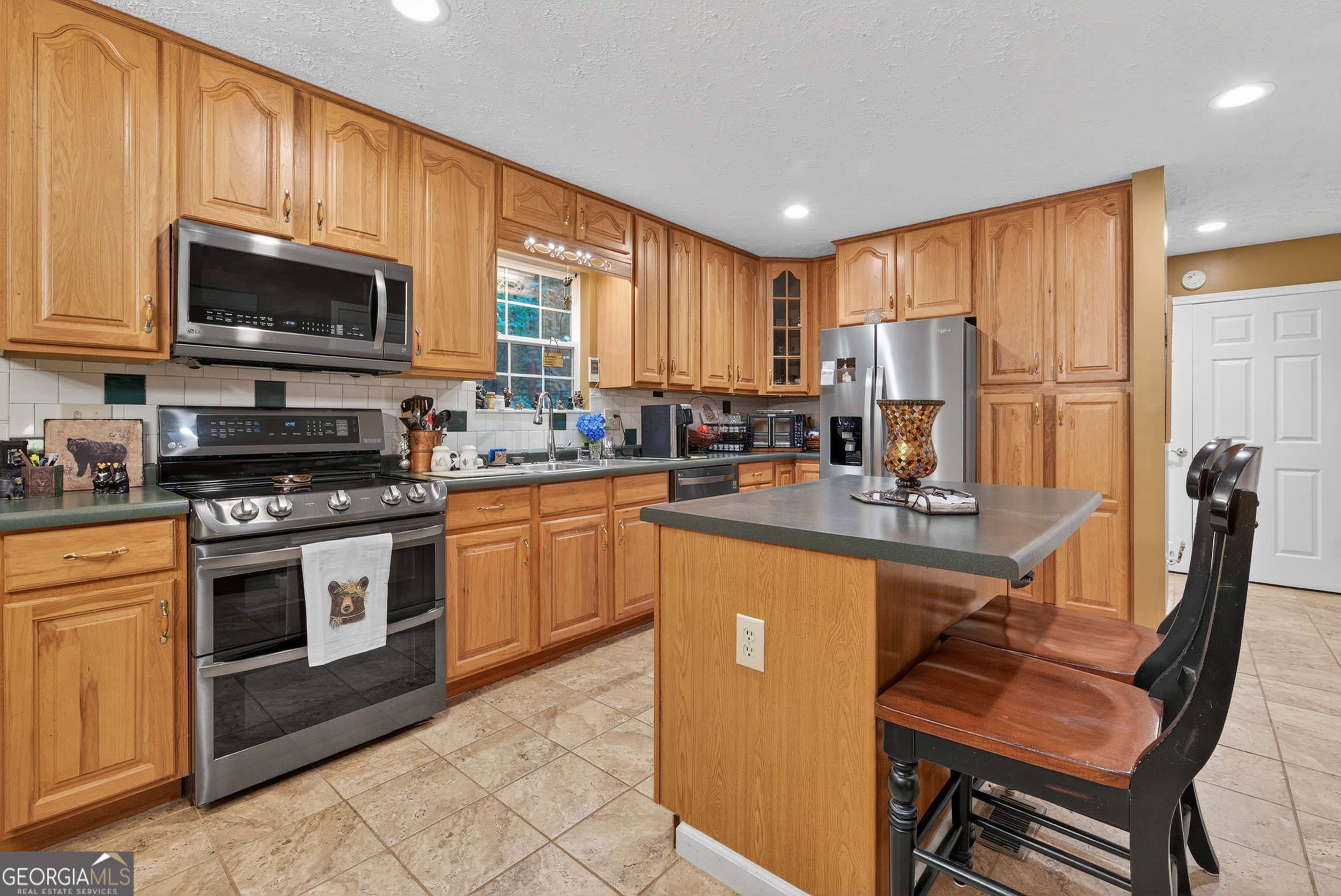 75 Juniper Trail Clayton, GA 30525 - Photo 8 of 38 a kitchen with stainless steel appliances granite countertop a stove a sink a microwave a refrigerator and cabinets