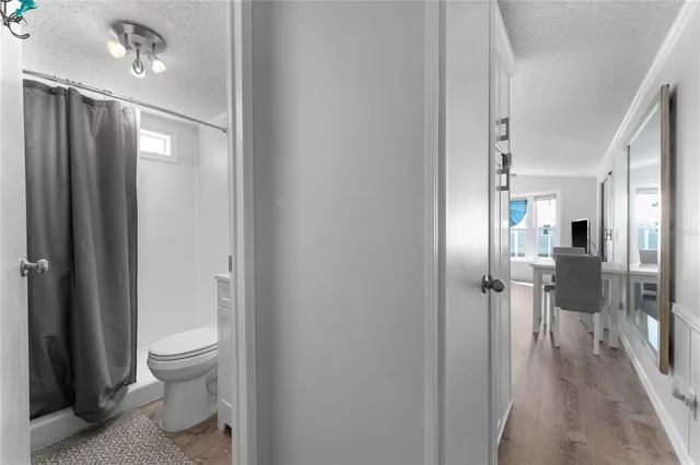 a bathroom with a granite countertop sink a toilet and shower