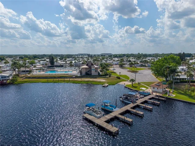 an aerial view of a residential houses with outdoor space swimming pool and ocean view