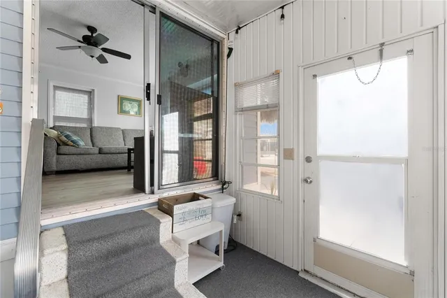 a living room with furniture and a glass door shower