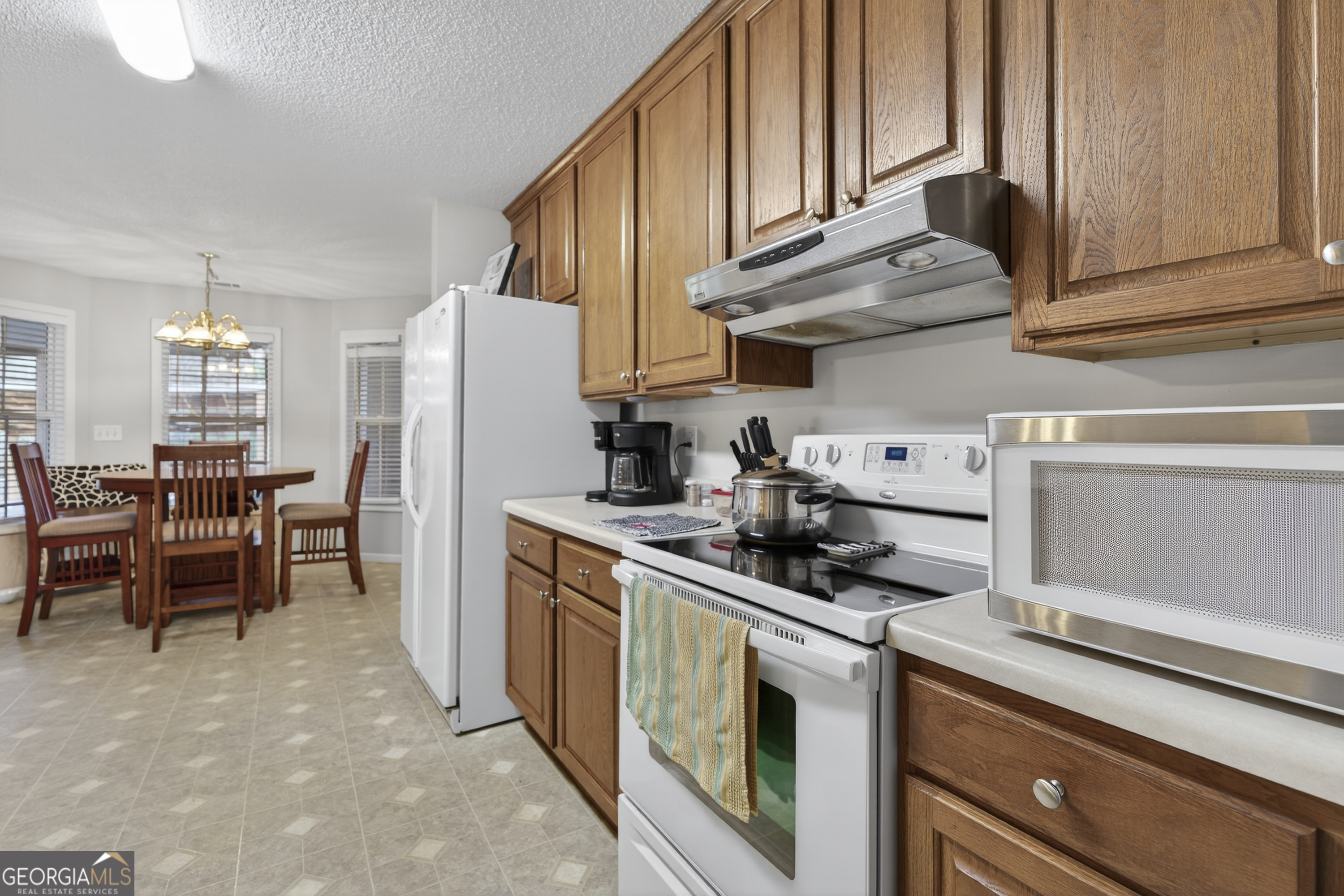 249 Southern Walk Circle Gray, GA 31032 - Photo 28 of 58 a kitchen with stainless steel appliances granite countertop a sink a stove and a refrigerator