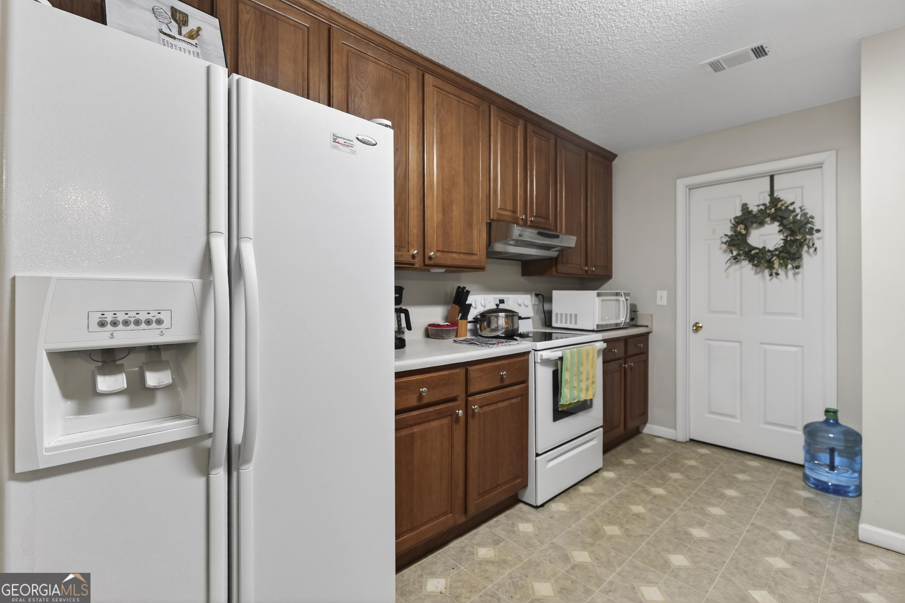 249 Southern Walk Circle Gray, GA 31032 - Photo 30 of 58 a kitchen with stainless steel appliances white cabinets and a refrigerator