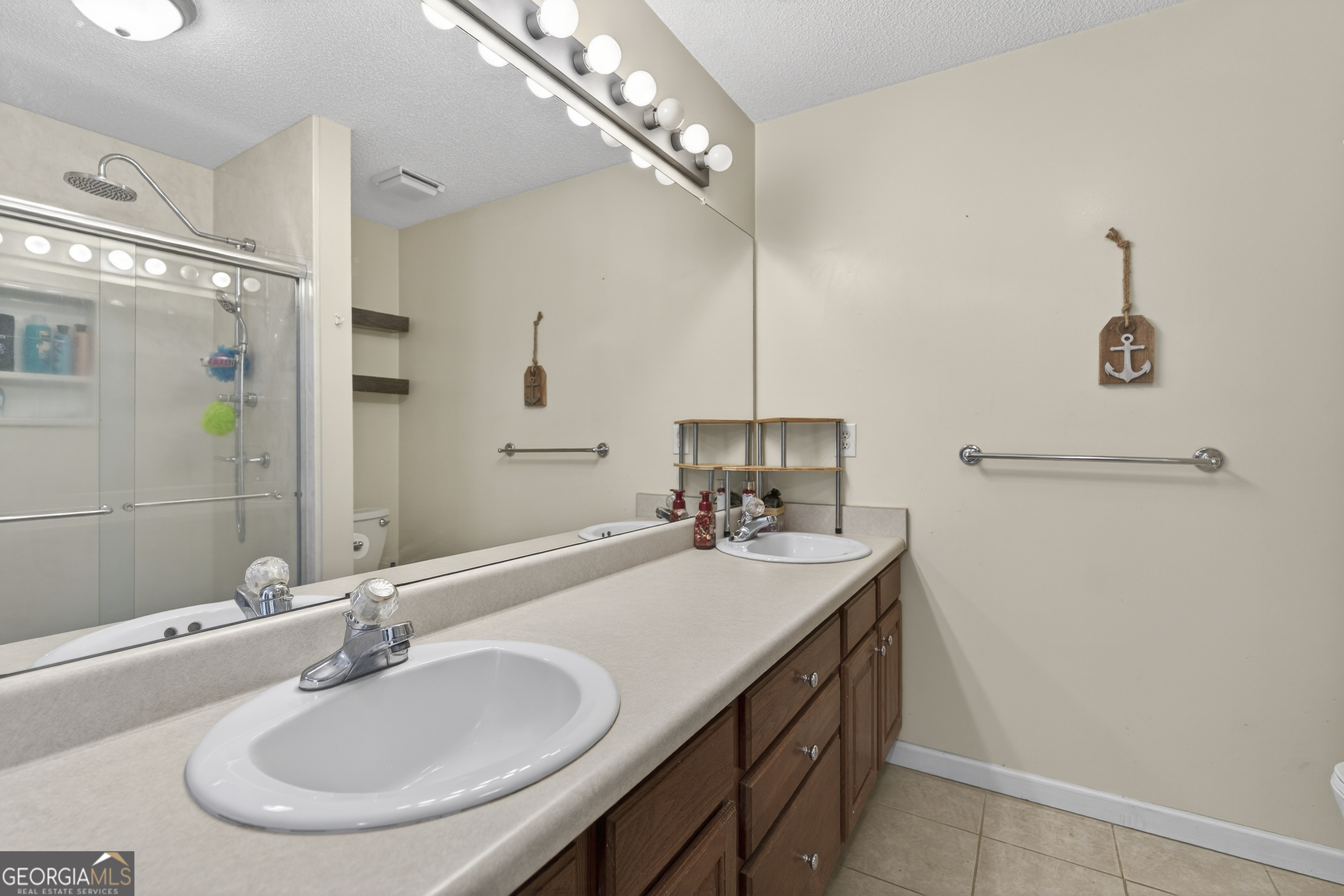 249 Southern Walk Circle Gray, GA 31032 - Photo 35 of 58 a bathroom with a sink double vanity and a mirror