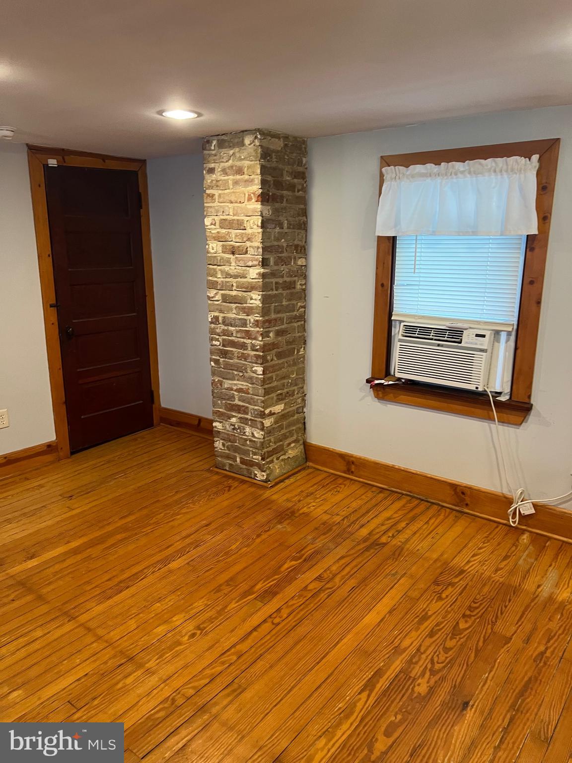 317 West Commerce Street Smyrna, DE 19977 - Photo 13 of 30 a view of an empty room with wooden floor and a window
