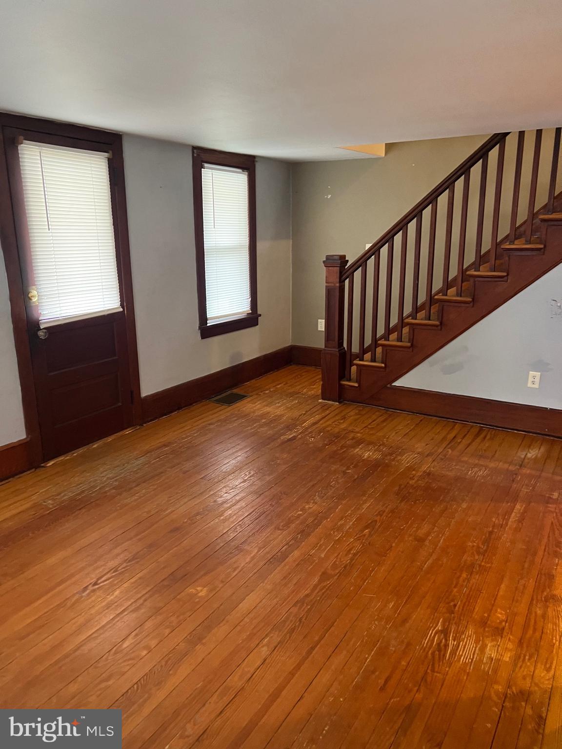 317 West Commerce Street Smyrna, DE 19977 - Photo 15 of 30 an empty room with wooden floor and windows