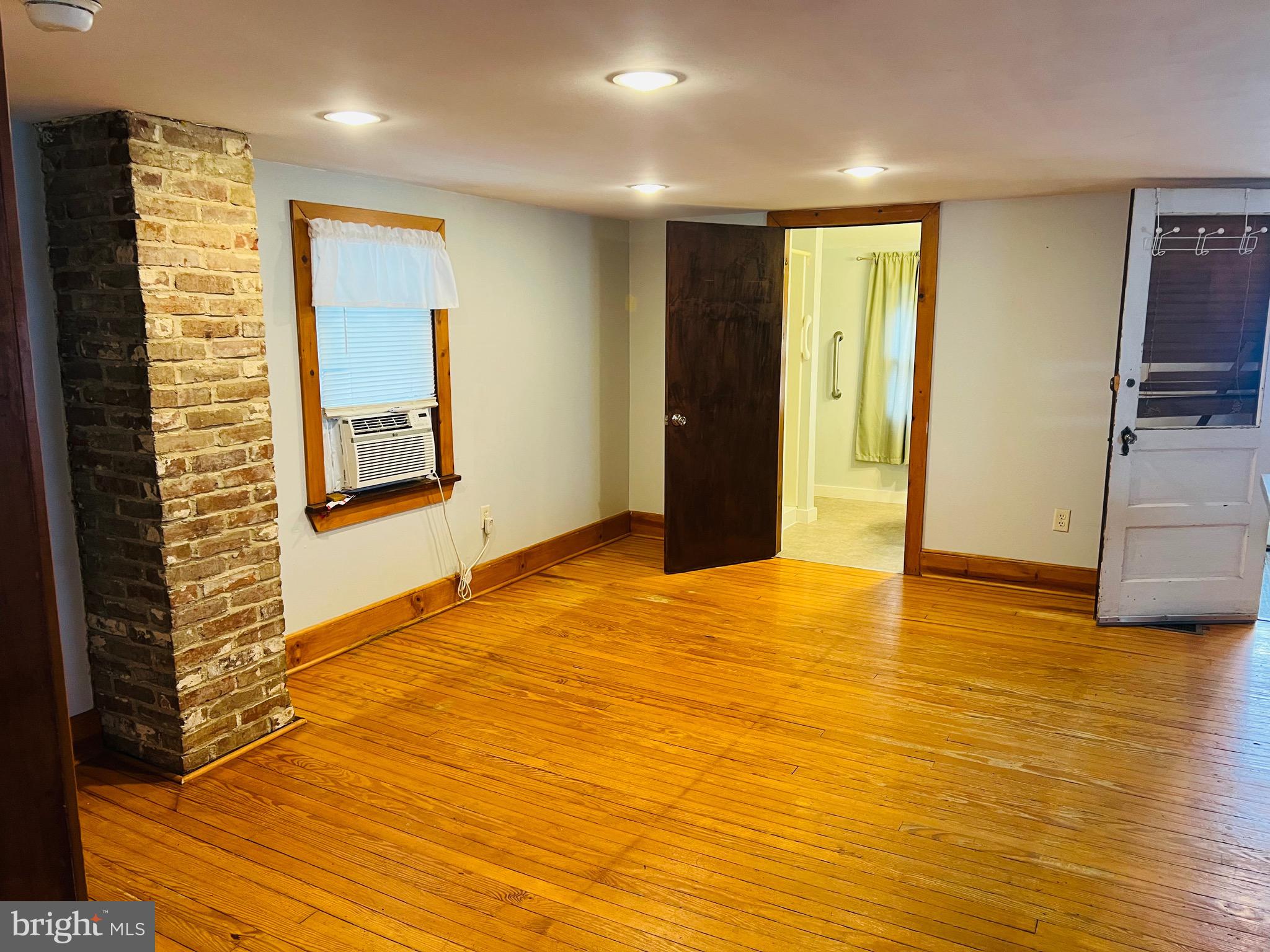 317 West Commerce Street Smyrna, DE 19977 - Photo 17 of 30 a view of an empty room with wooden floor and a window