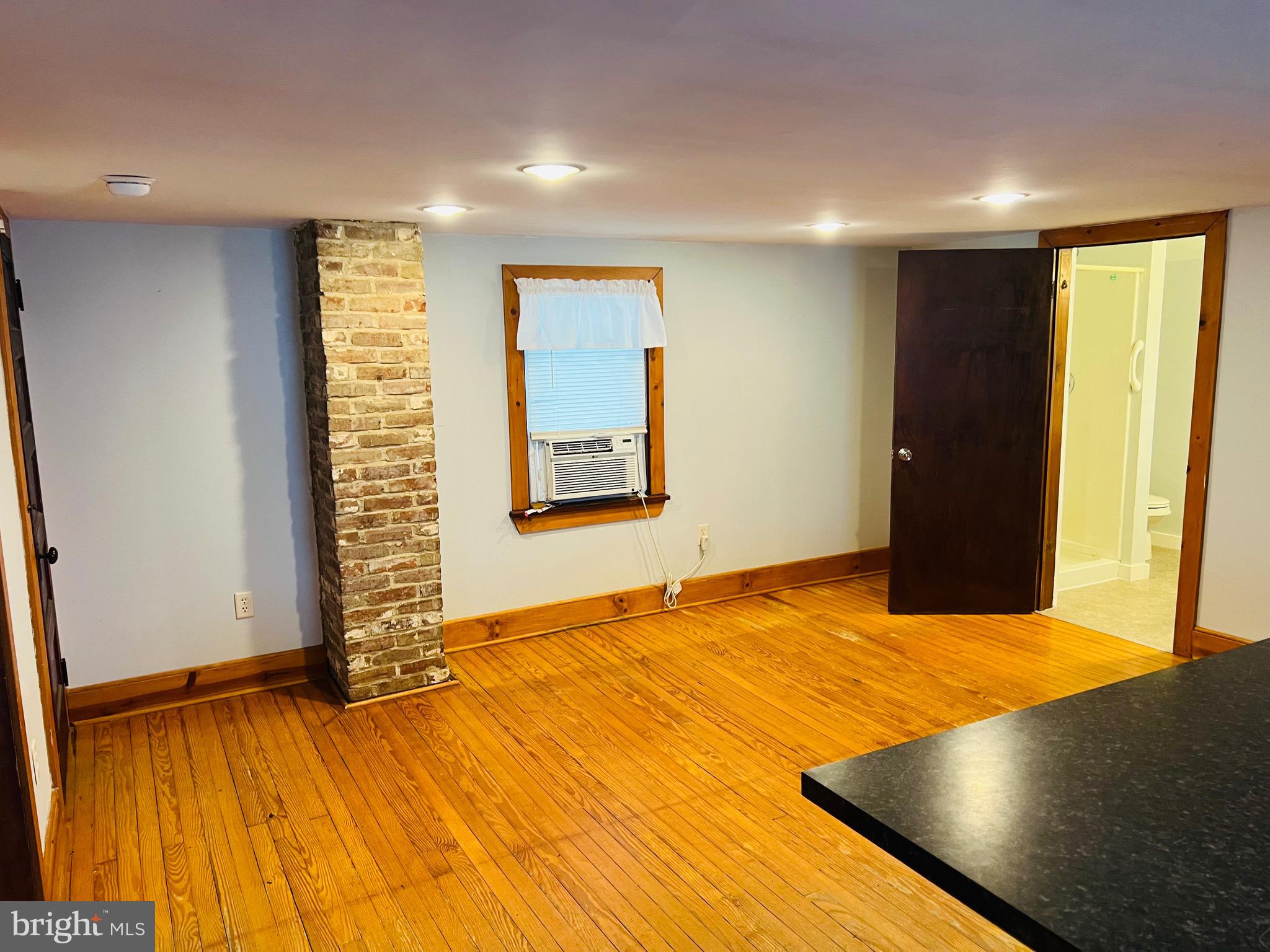 317 West Commerce Street Smyrna, DE 19977 - Photo 8 of 30 a view of an empty room with wooden floor and a window