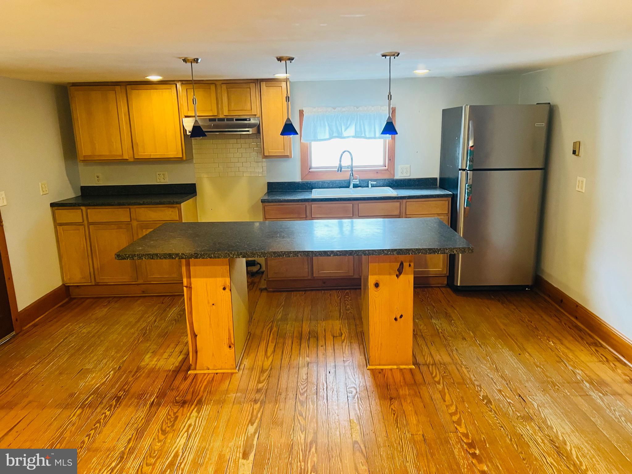 317 West Commerce Street Smyrna, DE 19977 - Photo 9 of 30 a kitchen with a sink appliances and cabinets