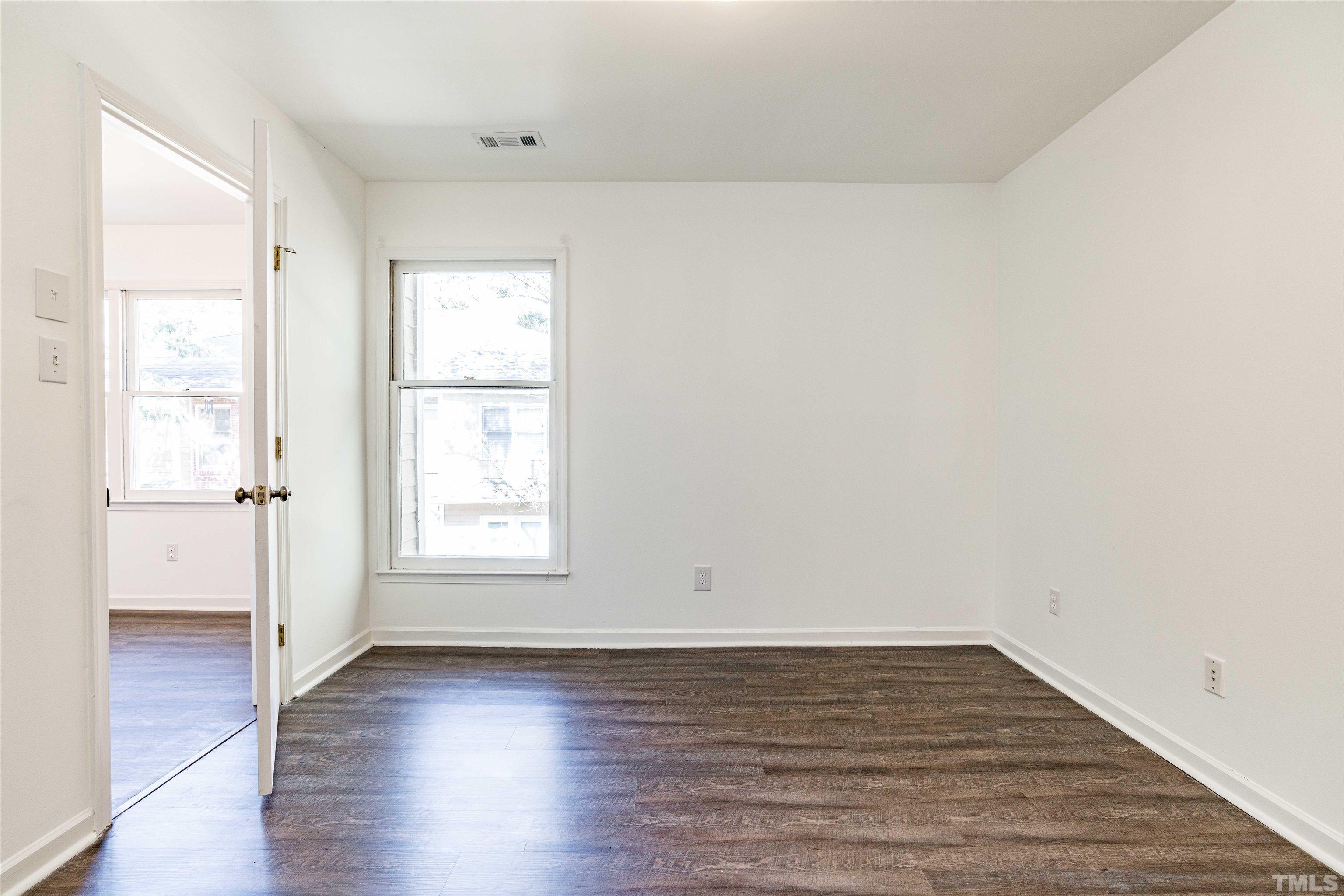 3643 Mill Run, Unit 3643 Raleigh, NC 27612 - Photo 18 of 25 an empty room with wooden floor and window