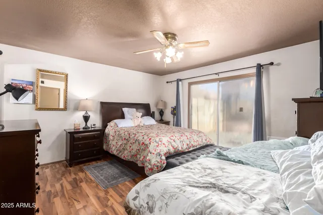 a bedroom with two large bed and a chandelier