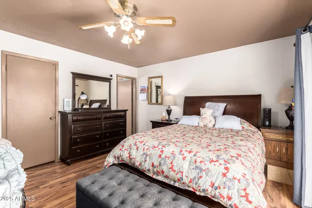 a bedroom with a bed and wooden floor