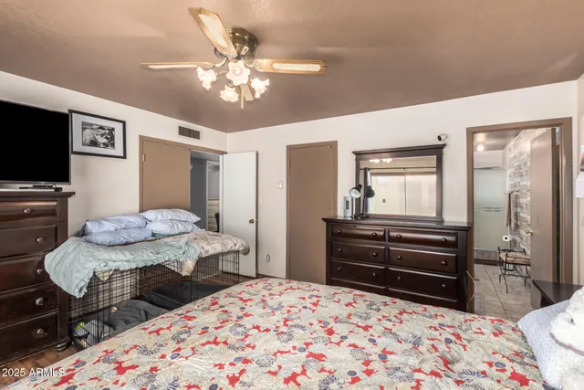 a bedroom with a bed and a television