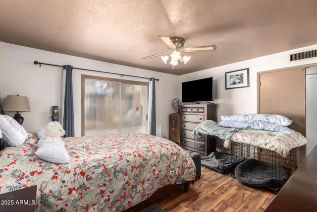 a bedroom with a large bed and a tv