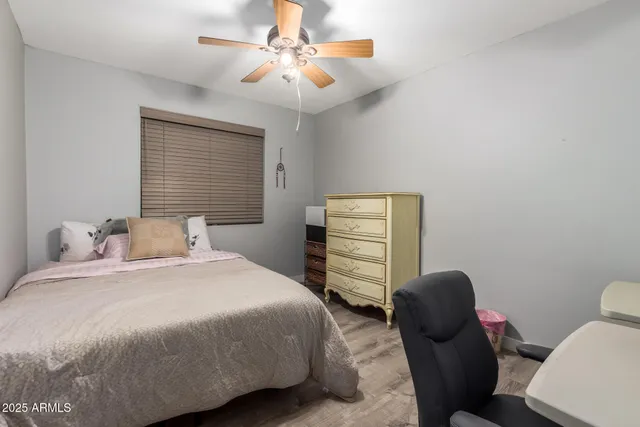 a bedroom with a bed and chair