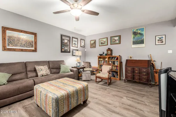 a living room with furniture and wooden floor