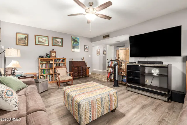 a living room with furniture a flat screen tv and a fireplace