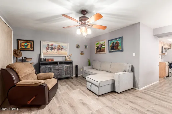 a living room with furniture and a wooden floor