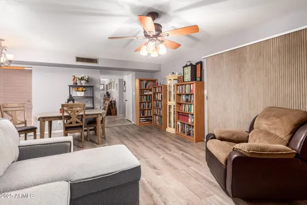 a living room with furniture and wooden floor